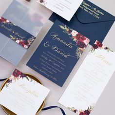 the wedding stationery is laid out on top of each other