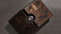 an image of a black and gold box with designs on the front, inside and out