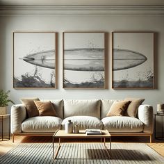 a living room with three paintings on the wall