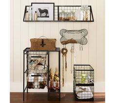 three shelves with baskets and other items on them in a living room, including a dog bone hanging from the wall