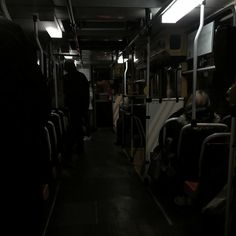 people are sitting on the bus in the dark