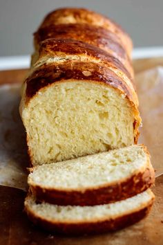 a loaf of bread sitting on top of a wooden cutting board