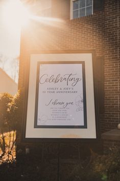 a sign in front of a brick building with the words celebrating printed on it's side