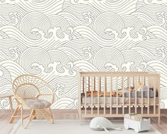 a baby's room with a crib, rocking chair and wallpaper design