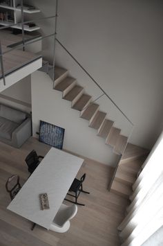 an aerial view of a living room and staircase