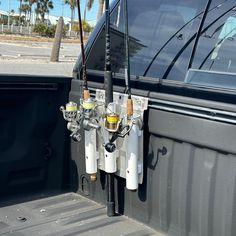 there are two fishing rods attached to the back of a truck's tailgate