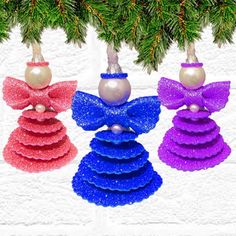 three christmas ornaments hanging from a tree