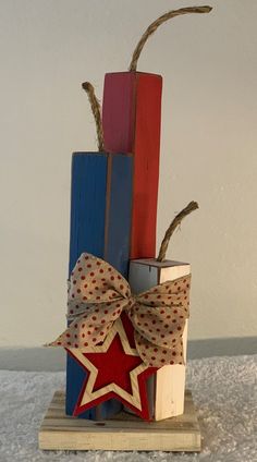 a red, white and blue wooden block with a star decoration on the front sitting on top of it