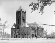 black and white photograph of an old building with a clock tower