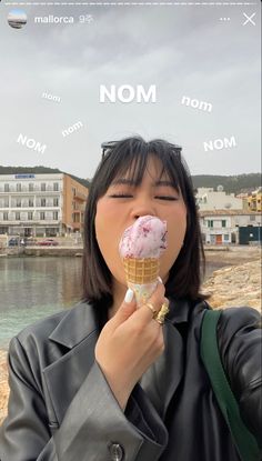 a woman eating an ice cream cone with the word mom above her head and on top of it