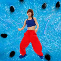 a woman standing in front of a blue pool