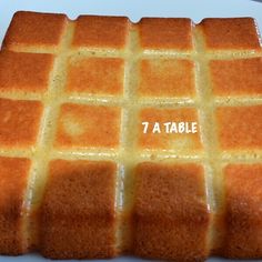 a cake that has been cut into squares and is sitting on a plate with the words 7 a table