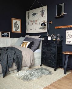 a bed room with a neatly made bed next to a night stand and two pictures on the wall