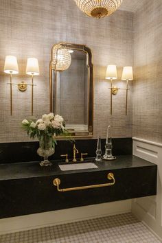 a bathroom with a sink, mirror and lights