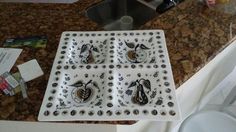 a kitchen counter with a sink, stove top and various utensils on it