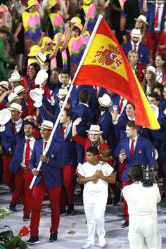 a group of people in suits and ties holding flags