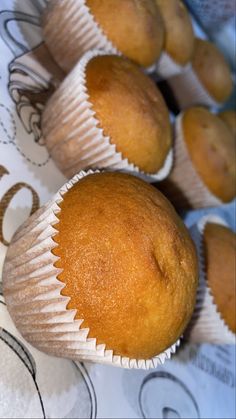 several muffins sitting on top of a paper wrapper next to each other