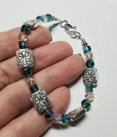 Women's handmade bracelet. Green and pink combo with silver accents.  Silver lobster claw clasp. Cube Design, Green Crystal, Design Silver, Handmade Bracelet, Silver Accents, Green Crystals, Silver Flowers, Lobster Claw, Handmade Bracelets