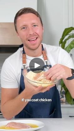 a man in an apron holding a bowl of food