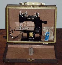 an old fashioned sewing machine in a case