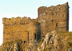 an old castle sitting on top of a cliff