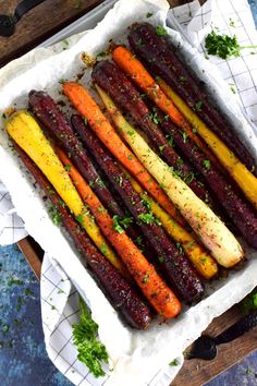 roasted carrots with parsley on top in a baking dish, ready to be eaten