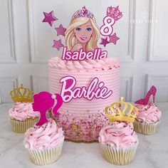 a barbie birthday cake and cupcakes with pink frosting