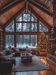 a living room filled with furniture and a christmas tree in front of a large window