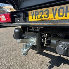 the rear end of a truck with its brake levers on it's flatbed