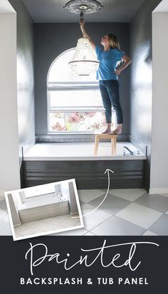 a woman standing on a ladder painting the ceiling in her kitchen with black and white checkered flooring