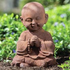 a small buddha statue sitting in the dirt