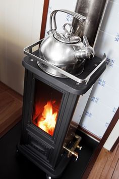 a stove with a tea pot on top of it