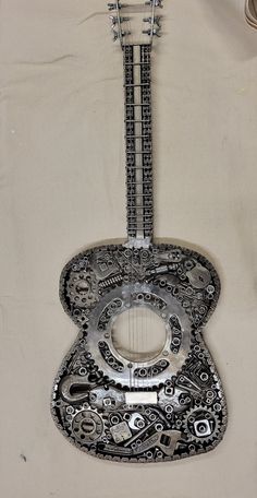 an intricately designed guitar is hanging on the wall