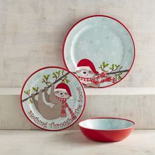 two red and white plates with slotty on them, one is holding a tree branch