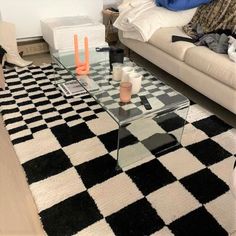 a living room filled with furniture and a checkered rug