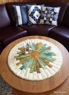 a living room with a brown couch and round coffee table on top of carpeted flooring