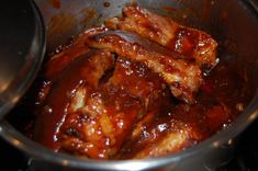 some meat is cooking in a pot on top of the stove and it looks like they have been cooked