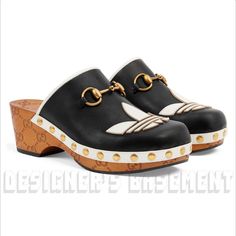 Brand New Authentic Gucci X Adidas Woman Black Leather With White Trefoil Logo Wooden Gg Platform Mule Clogs Slide Shoes Rp: $1,250 Style: 702218 Dtnp0 1060 Size: 36.5eu - 6.5us (Insole 9 5/8") Made In Italy From Gucci X Adidas Collaboration Collection Black Leather With White Leather Trim, Wooden Clog With Rubber Sole 2 3/8" High Heel And 1 1/8" Platform White Trefoil Leather Patch On Vamp Antique Gold-Toned Horsebit On The Vamp Antique Gold-Toned Studs Around The Sides Branded Outsole Easy Sli Calf Leather Clogs With Rubber Sole And Round Toe, Gucci Black Mules With Round Toe, Black Gucci Mules With Round Toe, Luxury Leather Clogs With Rubber Sole, Gucci Mules With Leather Sole And Calf Leather, Gucci Slip-on Mules With Leather Sole, Gucci Calf Leather Mules With Leather Sole, Designer Leather Clogs With Round Toe, Luxury Leather Closed Toe Clogs