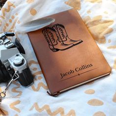 a camera and a book on a bed