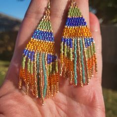 I Made These Striped Earrings Using Japenese Delica Beads In . Cobolt Rimbow, Galvanized Muscat, Silver Lined Orange, Mallard And Catcus Glazed Luster. Each Earring Has Over 450 Beads And Measures Approximately 2.75 Inches In Length 1 Inches In Width. Rainbow Beaded Fringe Earrings For Gift, Orange Tiny Beads Drop Earrings, Orange Beaded Drop Earrings, Bohemian Multicolor Faceted Beaded Earrings, Orange Drop Earrings With Tiny Beads, Unique Orange Beaded Earrings With Colorful Beads, Unique Orange Beaded Earrings, Orange Tiny Beads Earrings For Festival, Orange Tiny Beaded Earrings For Festival