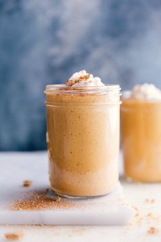 two jars filled with food sitting on top of a table