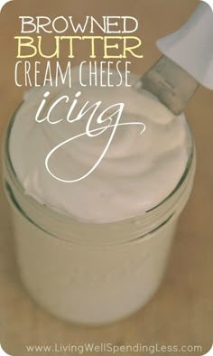 a glass jar filled with cream cheese sitting on top of a table