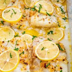 baked fish with lemons and herbs in a baking dish, ready to be eaten