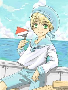 the boy is holding a small flag while sitting on a boat