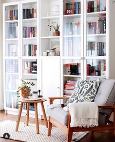 a living room filled with furniture and lots of bookshelves full of different types of books