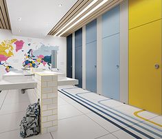 an empty room with yellow, blue and white lockers on the wall next to each other