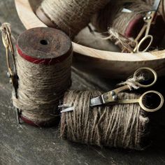 two spools of twine and some scissors on a table