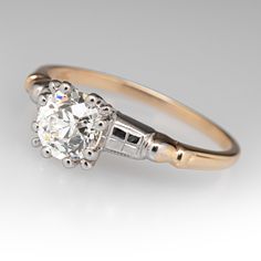 an engagement ring with a round diamond in the center and two small diamonds on each side