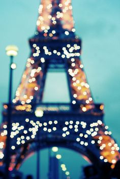 the eiffel tower is lit up at night