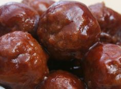 some meatballs sitting on top of a white plate